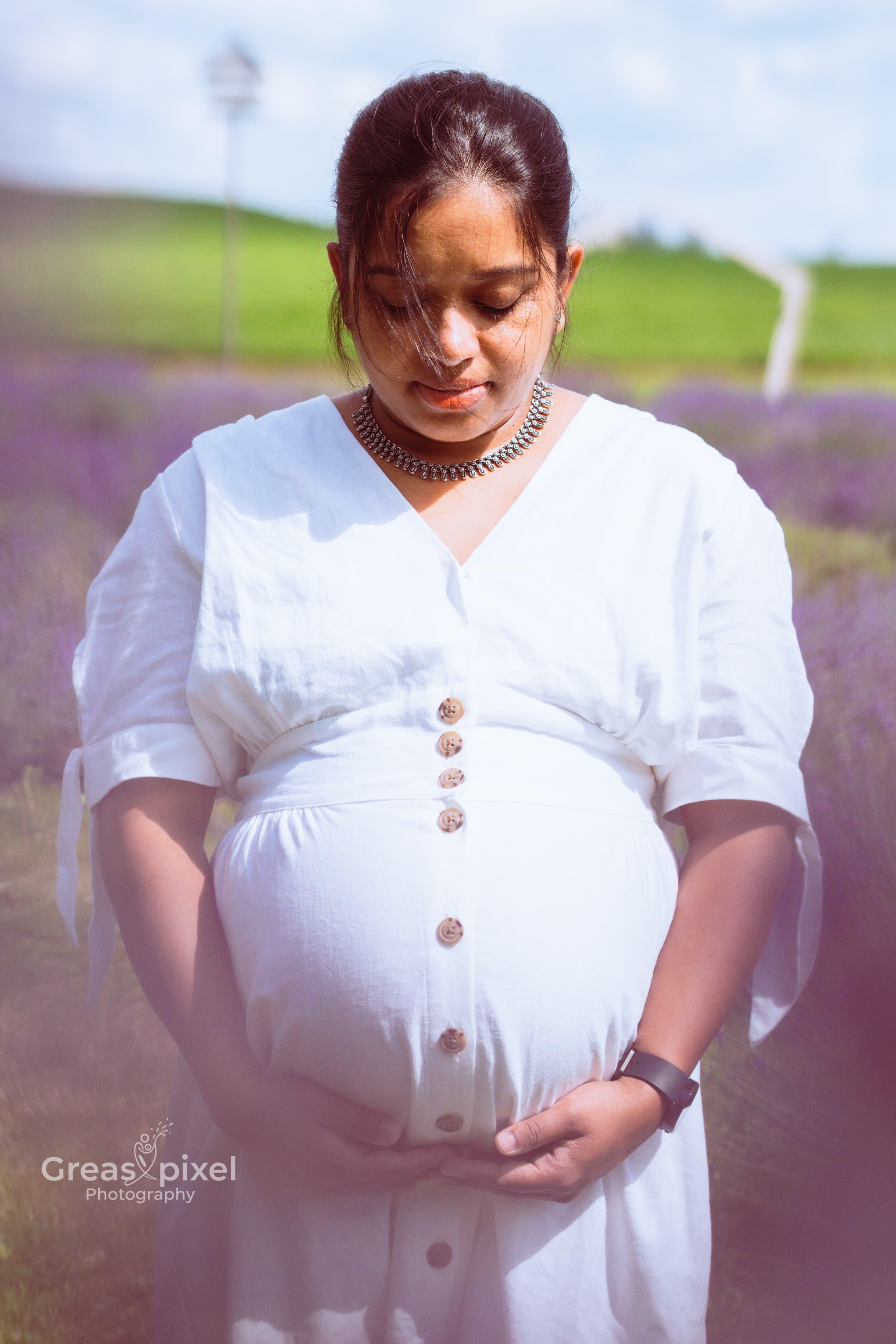 Outdoor maternity photo wearing white dress in lavender farm in Kitchener