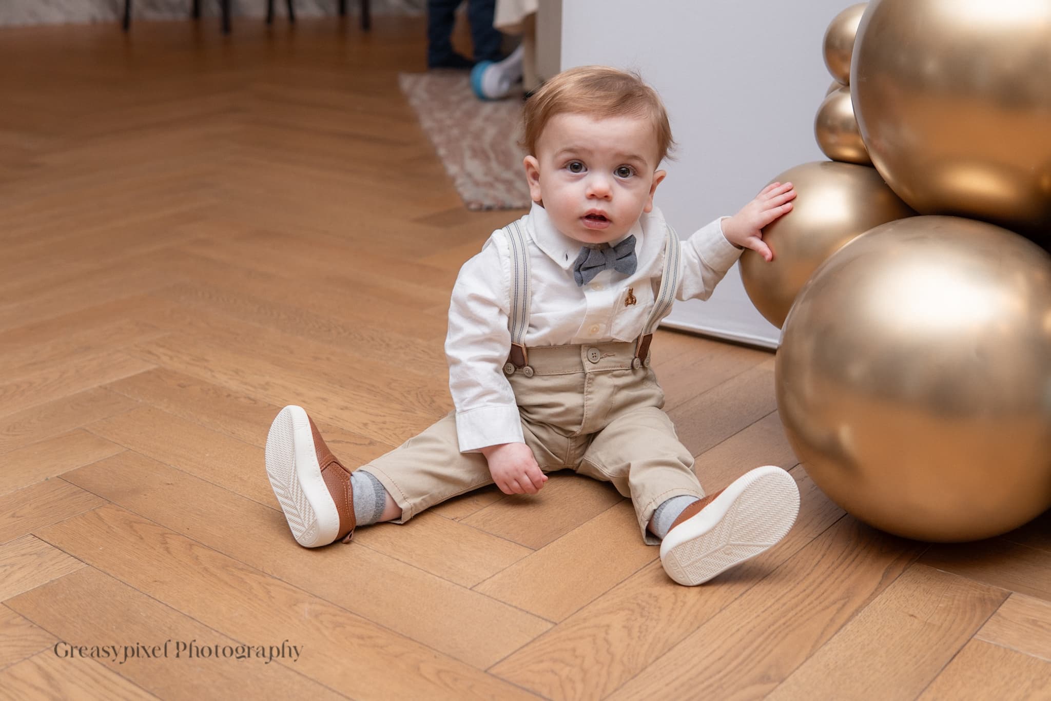 First birthday photography Waterloo - baby playing with metallic balloons
