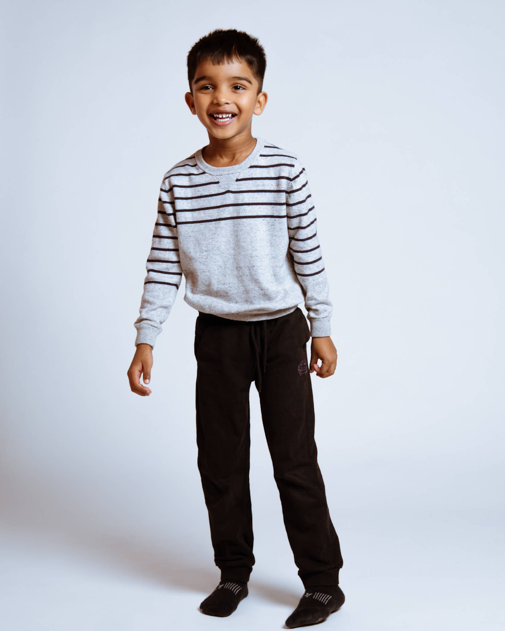 Full-length portrait of a smiling young boy