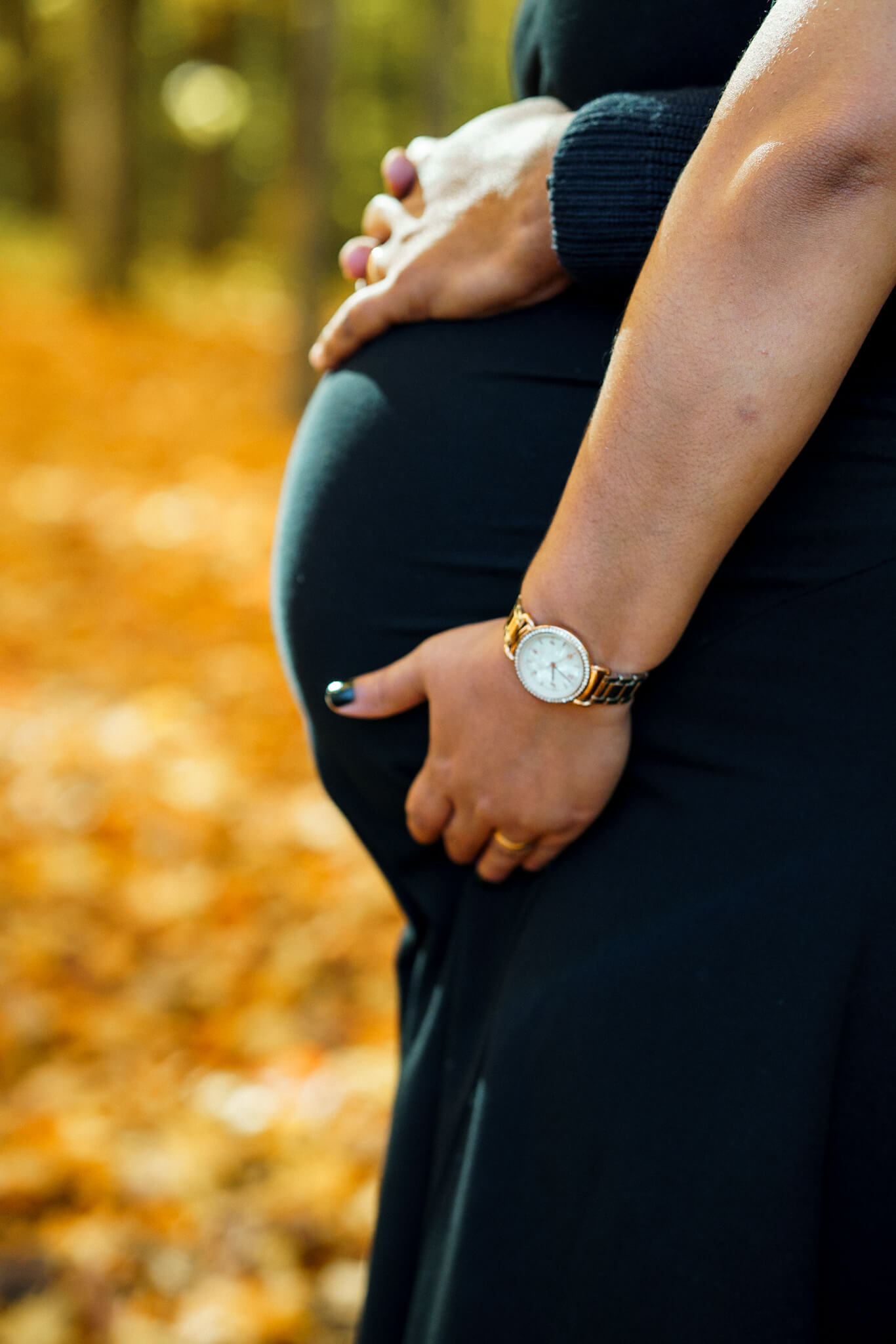Profile silhouette of a pregnant woman in a black dress