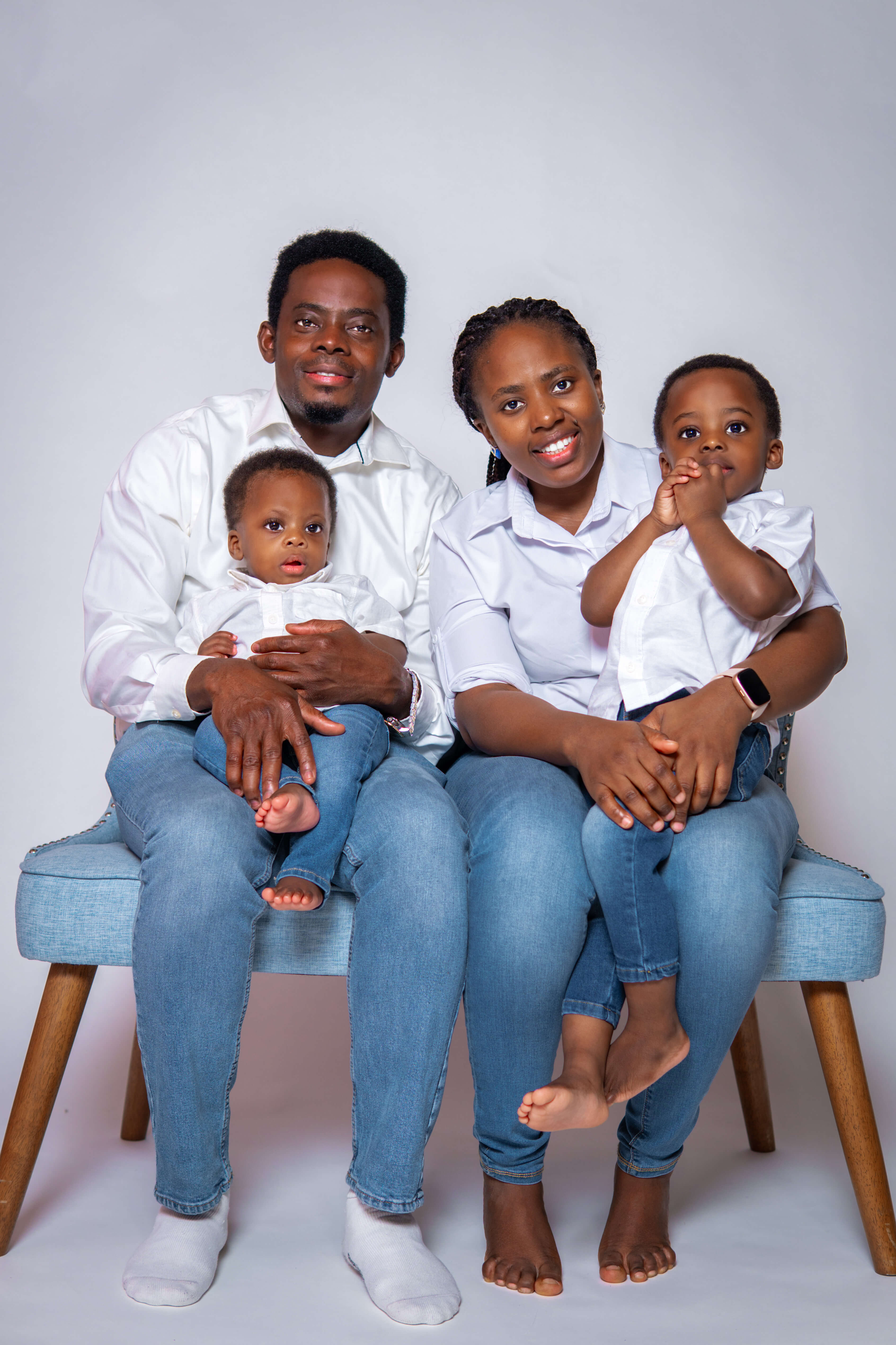 Two brothers sitting together with birthday balloons in the background